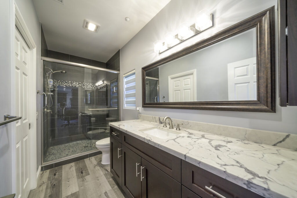 This spacious bathroom has plenty of counter space, and the walk in shower is safe for anyone who needs to age in place. Shower grab bars, a shower bench, and non slip tile make this a safe bathroom for a senior to use.