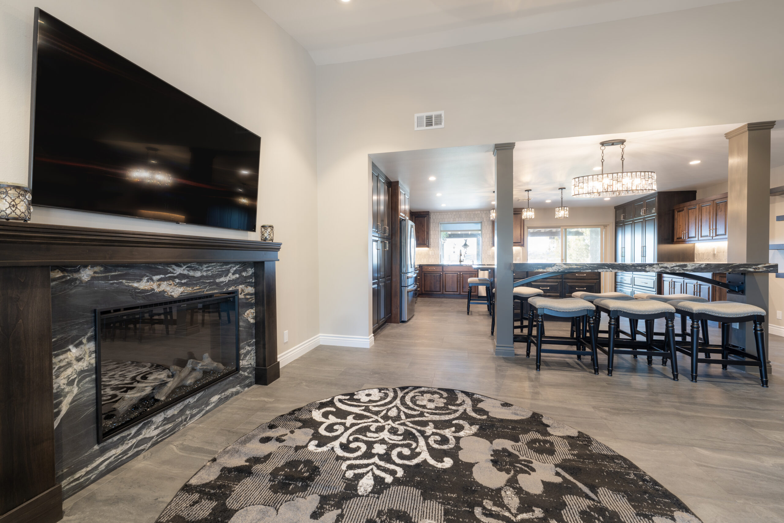 The custom black cabinets and mantle blend seamlessly with the flat screen tv for an elegant, modern look.