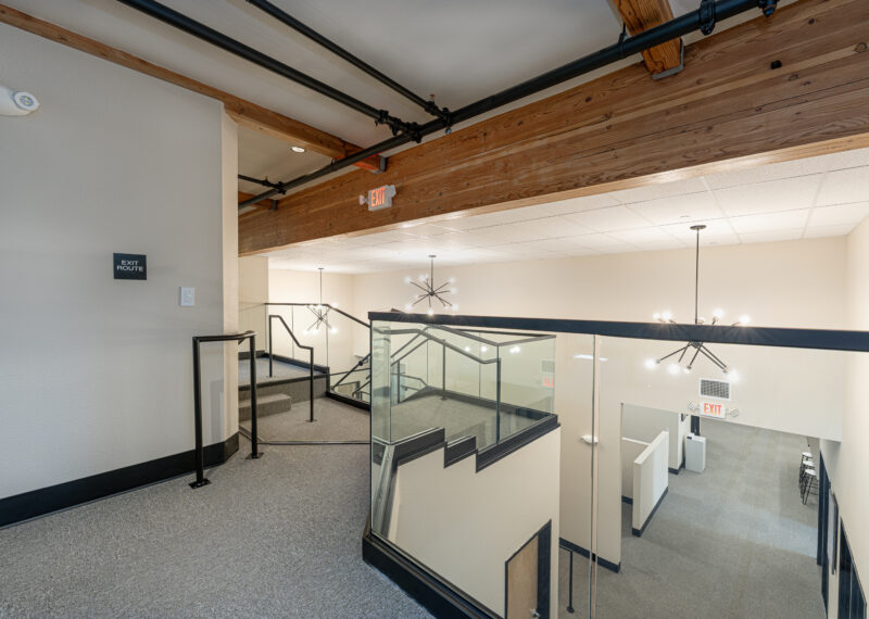 Upstairs stairway with large exposed beams