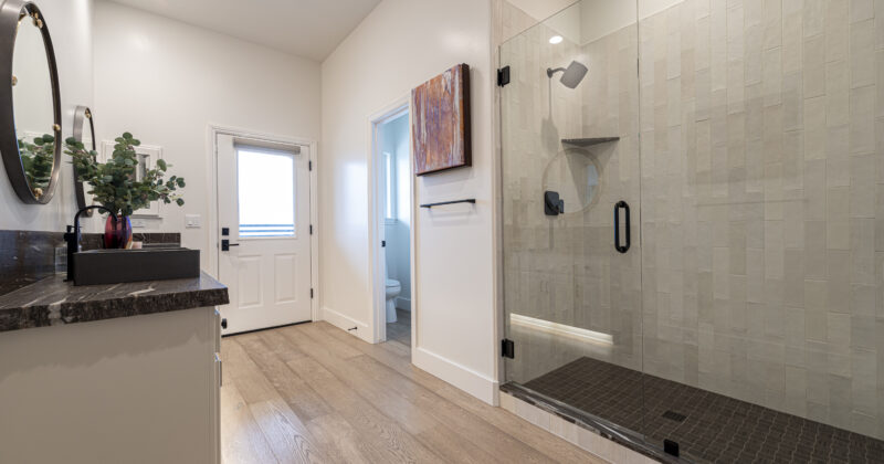 Stunning master bathroom remodel with walk in shower, double sinks, and LED cabinet lighting.