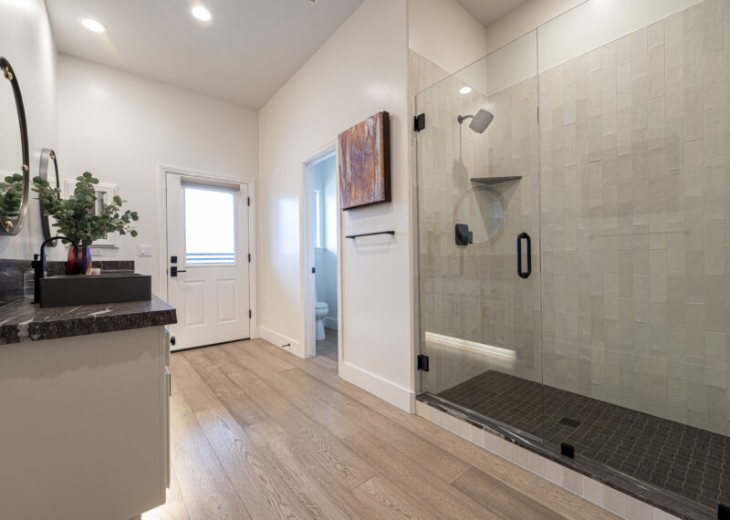 Stunning master bathroom remodel with walk in shower, double sinks, and LED cabinet lighting.