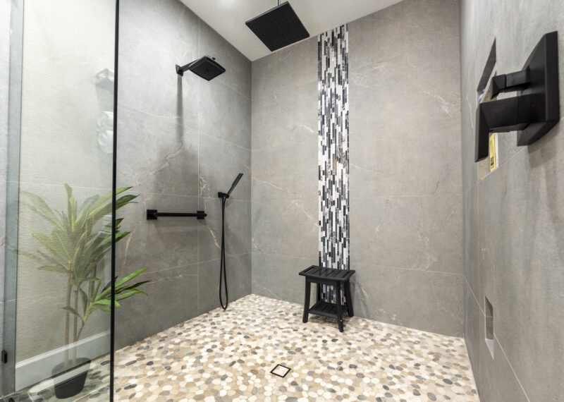 ADA Accessible roll in shower with multiple faucets and showerheads for safety and ease