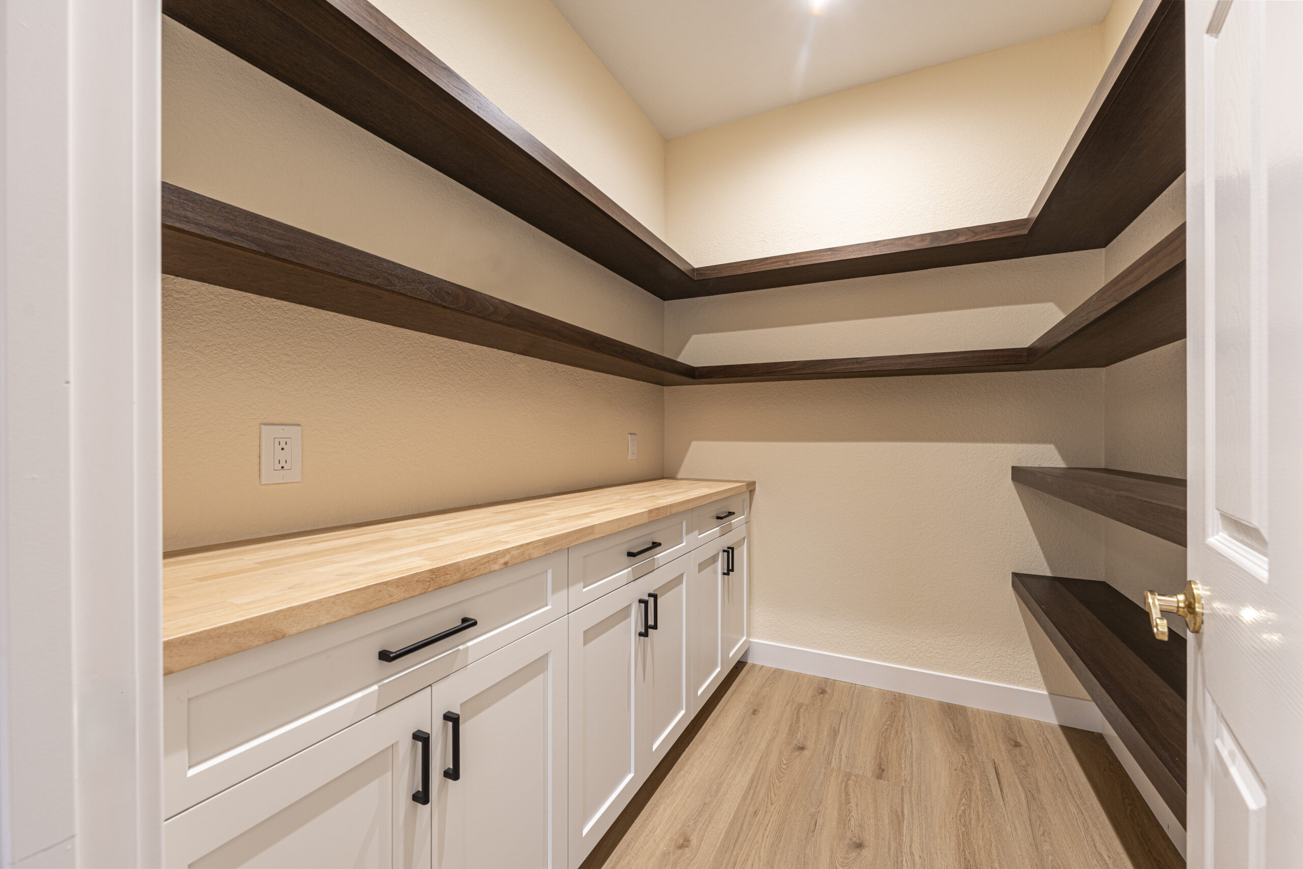 Walk in pantry with shelving and storage in a kitchen remodel by Youngren Construction