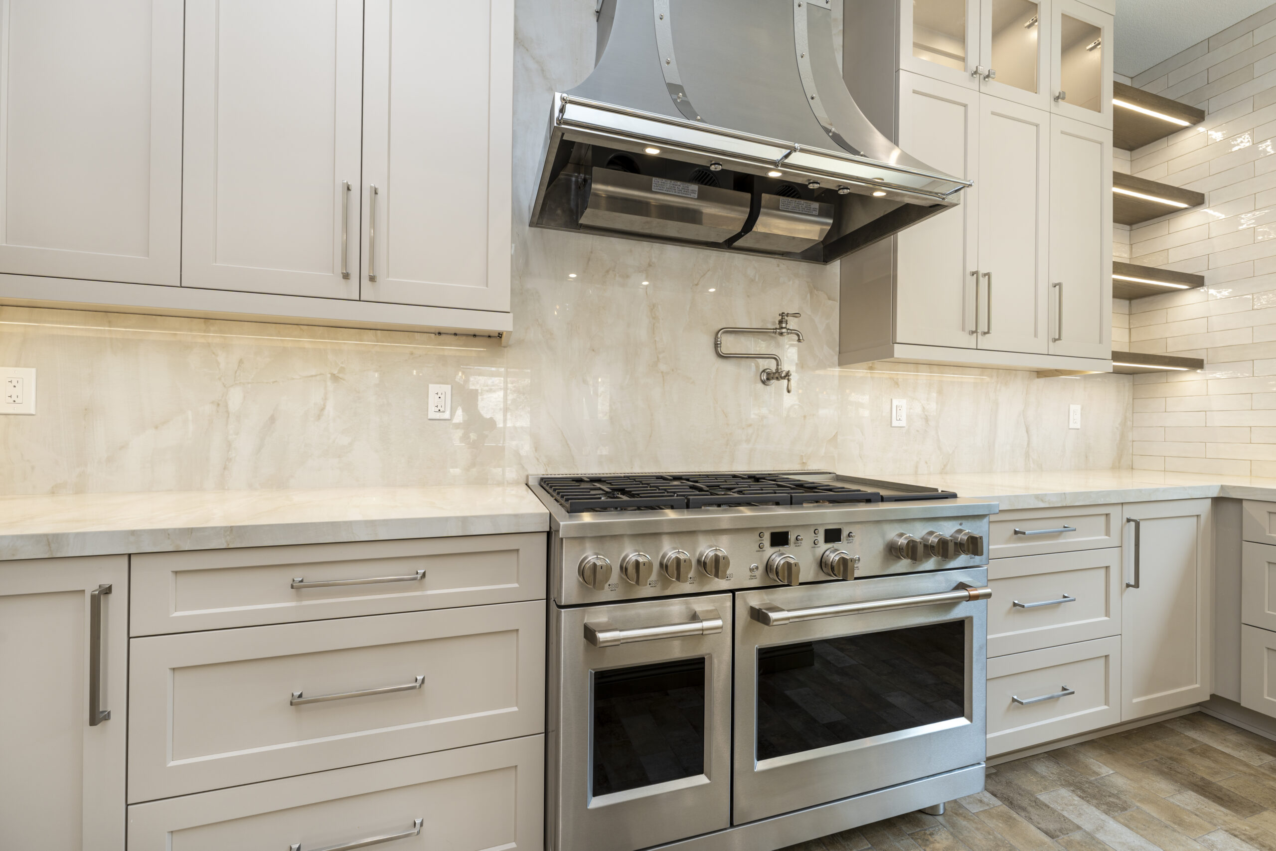 New stainless steel oven and range hood with sleek new countertops.