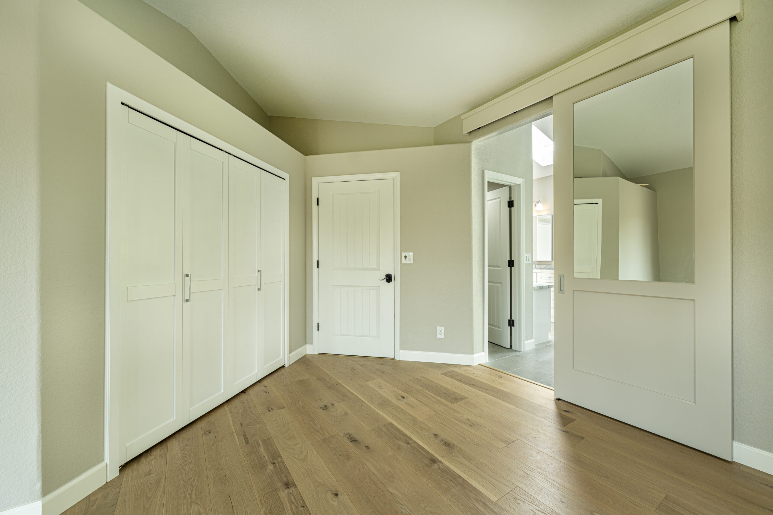 New closet and bedroom doors in this master bedroom remodel by Youngren Construction